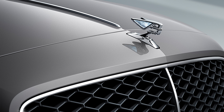 Bentley Guatemala New Bentley Flying Spur sedan bonnet detail in Silverlake paint with Illuminated Flying B bonnet badge and matrix grille with chrome surround