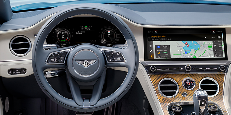 Bentley Guatemala New Bentley Continental GT Azure coupe front interior in Linen and Brunel blue hides, showing steering wheel and driver's instruments